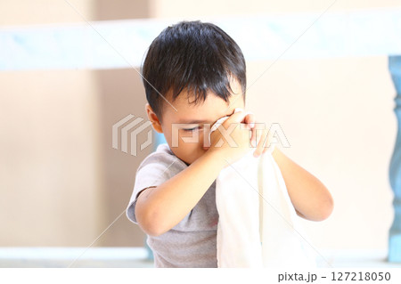 Emotional Child Holding Cloth Wiping Tears, Displaying Vulnerability and Innocence in Soft Natural Light, Capturing the Essence of Childhood Emotions and Comfort Emotional Child Holding Cloth Wiping Tears, Displaying Vulnerability and Innocence in Soft Natural Light, Capturing the Essence of Childhood Emotions and Comfort 127218050