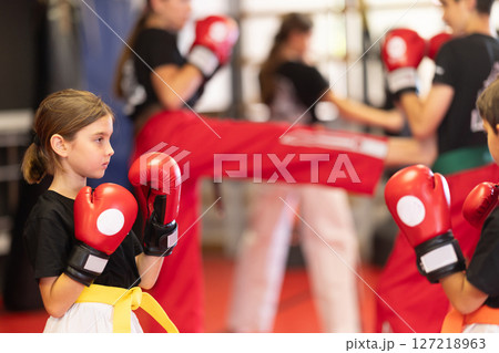 Children in gloves at boxing training 127218963