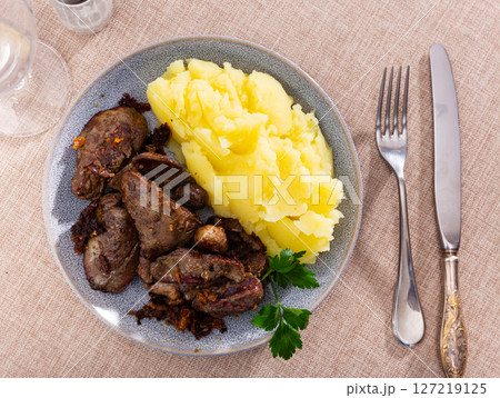 Chicken liver served with puree on plate 127219125