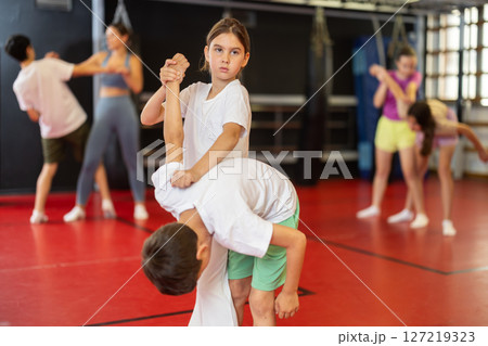 Boy and girl practice self-defense in pairs Boy and girl practice self-defense in pairs 127219323