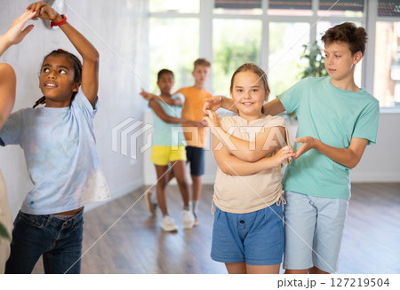Tween girl and boy dancing waltz as couple in choreographic studio 127219504