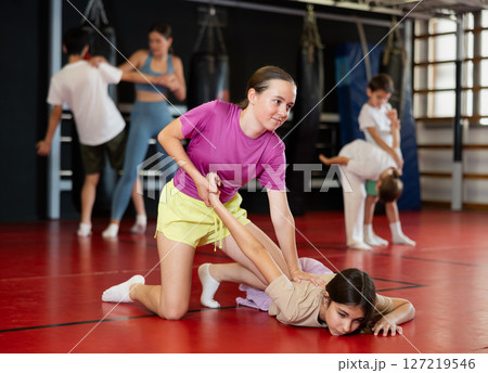 Two teenage girls practice self-defense in pairs 127219546