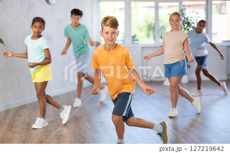 Dance studio - smiling girls and boys in dance lesson 127219642