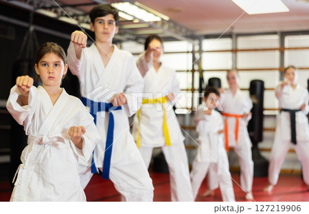 Children students repeat position and perform sequence of punches and painful techniques kata Children students repeat position and perform sequence of punches and painful techniques kata 127219906