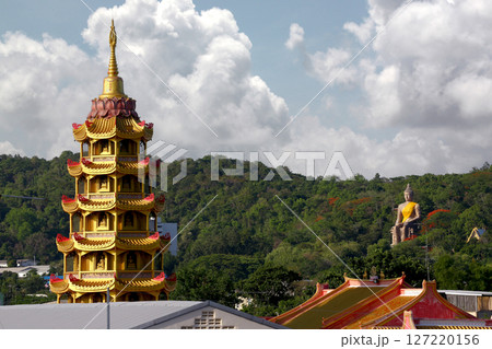 Top of pagoda of Wat Tham Suea, surrounded by trees and white clouds. Top of pagoda of Wat Tham Suea, surrounded by trees and white clouds. 127220156