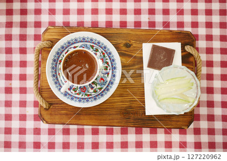 Turkish Coffee in Floral Cup on Checkered Tablecloth 127220962