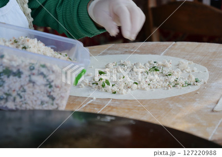 Creating Traditional Dough by Hand with Fresh, Flavorful Fillings Inside Creating Traditional Dough by Hand with Fresh, Flavorful Fillings Inside 127220988