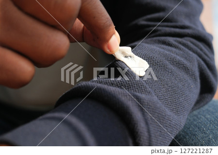 Detailed instructions for effectively removing chewing gum from fabric, with closeup view focus Detailed instructions for effectively removing chewing gum from fabric, with closeup view focus 127221287
