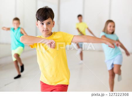 Preteen boy dancing lezginka during group class in choreographic studio Preteen boy dancing lezginka during group class in choreographic studio 127222308