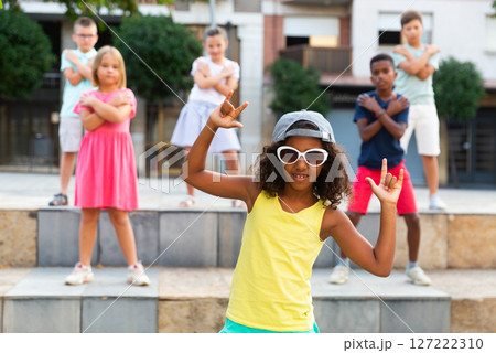 African american preteen b-girl in sunglasses dancing with friends outdoors African american preteen b-girl in sunglasses dancing with friends outdoors 127222310