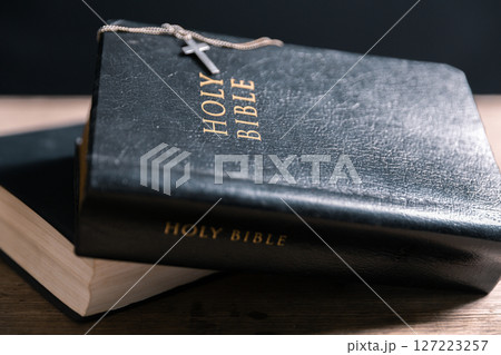 Religious belief concept Close up prayer Christian church service Bible Holy cross Spiritual power Blurred background Desk copy space Heaven God Catholic faith Praise book Jesus worship Gospel symbols 127223257