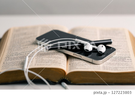 Close-up religious technology headphones pray bible church laptop Jesus Christ Holy Spirit Sunday service spiritual power blur background phone concept heaven belief gospel faith praise worship god Close-up religious technology headphones pray bible church laptop Jesus Christ Holy Spirit Sunday service spiritual power blur background phone concept heaven belief gospel faith praise worship god 127223803