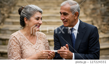 People sharing a Joyful Moment Outdoors With Warm Smiles 127224331