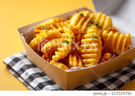 Tempting waffle fries, sunny corner, pastel yellow backdrop, clean food style, candlelight radiance 127224795