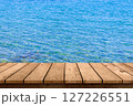wooden table top with blue sea summer background. 127226551