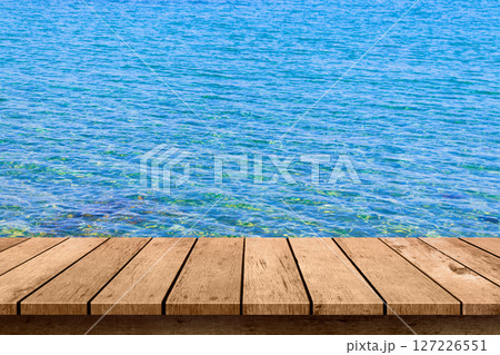 wooden table top with blue sea summer background. 127226551