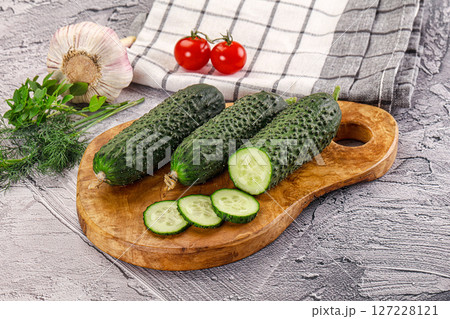 Raw green cucumbers with slices 127228121
