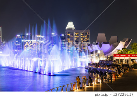 Beautiful view of the nightly music, water, and light show at Marina Bay Sands, here is an integrated resort fronting Marina Bay in Singapore. Beautiful view of the nightly music, water, and light show at Marina Bay Sands, here is an integrated resort fronting Marina Bay in Singapore. 127229117