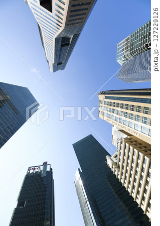 Low-angle building view of the modern office skyscrapers in the financial district of Raffles Place, Singapore. 127229126