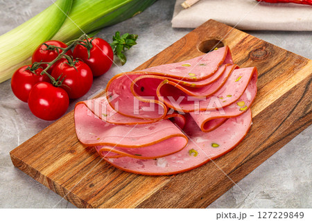 Mortadella pork sausages slices heap 127229849