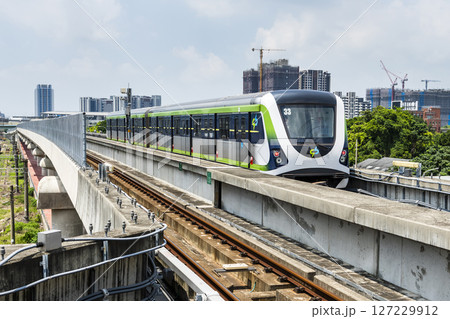 A Green Line train running on the elevated track of the Taichung Rapid Transit System in Taiwan.  127229912