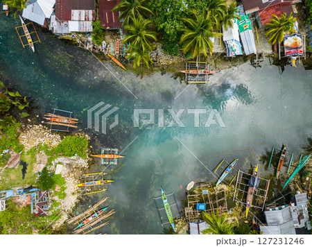 Drone view of Fishermans villages and clear cold spring river in Surigao del Sur. Philippines. Drone view of Fishermans villages and clear cold spring river in Surigao del Sur. Philippines. 127231246