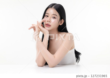 Glowing skin make up style of beautiful young Asian model isolated on white background. Glowing skin make up style of beautiful young Asian model isolated on white background. 127231965