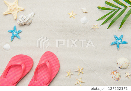 Pink flip flops, seashells, and starfishes creating relaxing summer beach background 127232571