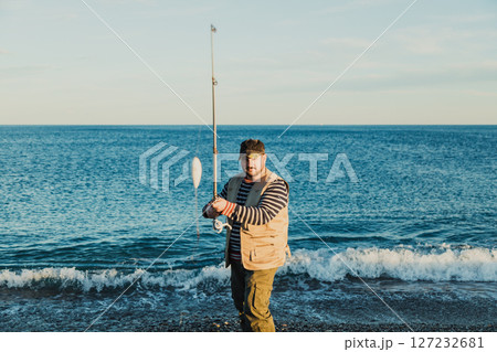 Man Fishing At The Seashore In The Morning  127232681