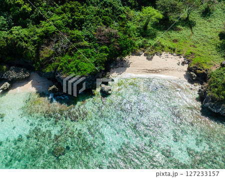 Ocean waves crashing on rocks and sands with sunlight reflection. Boracay, Philippines. 127233157