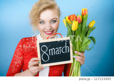 Woman holding bouquet of tulips flowers 127233895