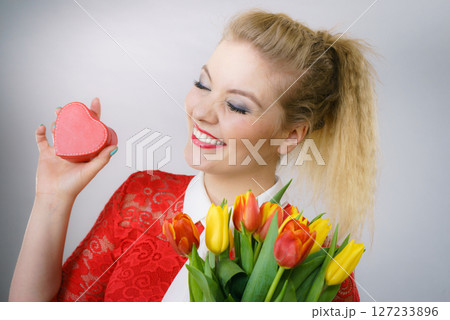 Woman holding tulips and gift 127233896