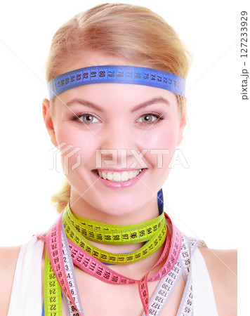 Obsessed fitness woman with a lot of colorful measure tapes Obsessed fitness woman with a lot of colorful measure tapes 127233929