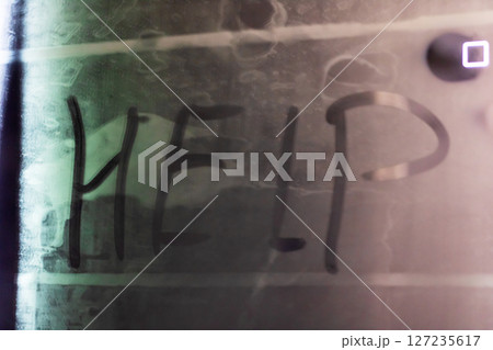 The word help is prominently spray painted on a nearby wall 127235617