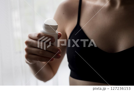 Woman holding antiperspirant. Woman holding antiperspirant. 127236153