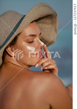 Suntan Lotion Woman Applying Sunscreen Solar Cream on Face. Skin care. Sun protection. Suntan Lotion Woman Applying Sunscreen Solar Cream on Face. Skin care. Sun protection. 127237417