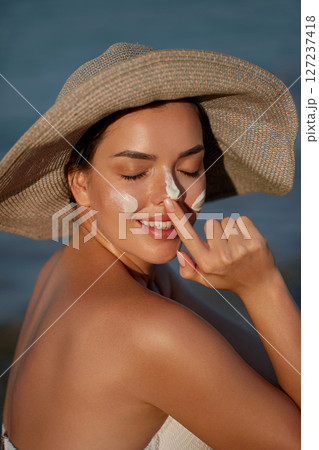 Beautiful Woman Face Portrait Beauty Skin Care Concept. Suncream. Suntan Lotion Beautiful Woman Applying on beautiful on Face. Sunscreen Solar Cream. Sun protection.The Girl Uses Moisturizer Sunblock. Beautiful Woman Face Portrait Beauty Skin Care Concept. Suncream. Suntan Lotion Beautiful Woman Applying on beautiful on Face. Sunscreen Solar Cream. Sun protection.The Girl Uses Moisturizer Sunblock. 127237418