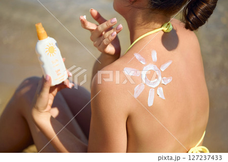 Suntan Lotion. Sexy Young Woman in Bikini Applying Sunscreen Solar Cream.Sun Protection. Sun Cream. Skin and Body Care.Girl Holding Moisturizing Sunblock. Sun shape on the shoulder. Skin Protection. Suntan Lotion. Sexy Young Woman in Bikini Applying Sunscreen Solar Cream.Sun Protection. Sun Cream. Skin and Body Care.Girl Holding Moisturizing Sunblock. Sun shape on the shoulder. Skin Protection. 127237433