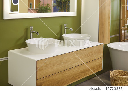 Modern bathroom with ceramic bathtub, double sinks and mirror above it, there are no people Modern bathroom with ceramic bathtub, double sinks and mirror above it, there are no people 127238224