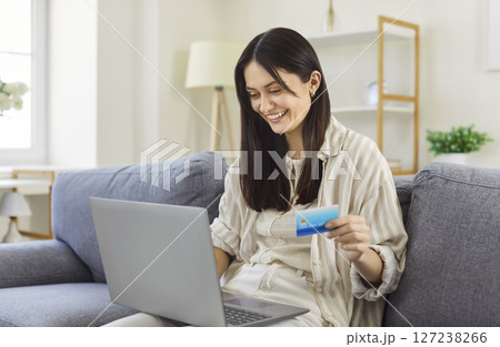 Happy Woman Shopping Online With Laptop At Home Happy Woman Shopping Online With Laptop At Home 127238266