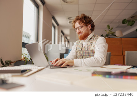 A Focused and Dedicated Professional Effectively Working Remotely in a Modern Office Environment A Focused and Dedicated Professional Effectively Working Remotely in a Modern Office Environment 127238440