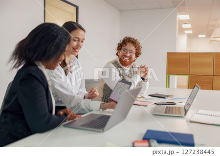 A Business Team Actively Collaborating in a Modern Office Environment for Optimal Outcomes A Business Team Actively Collaborating in a Modern Office Environment for Optimal Outcomes 127238445