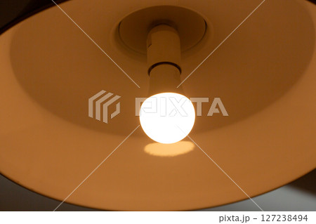 Ceiling lamps for interior decoration. A glowing lamp in the chandelier. 127238494