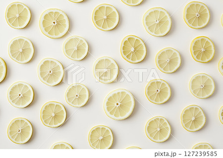 Fresh Lemon Slices on Light Background in a Decorative and Refreshing Pattern Design 127239585