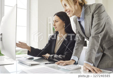 Women Colleagues Using Computer In Office Meeting Women Colleagues Using Computer In Office Meeting 127240385