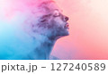 Locked on a cloud of smoke, with a pink and blue pastel-colored background, a minimal concept studio photograph. 127240589