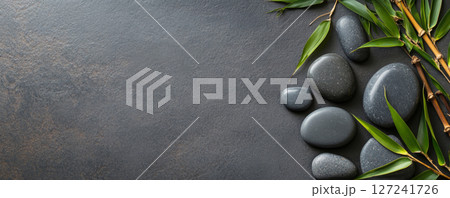 Zen Hot Stones with Bamboo on a Textured Slate Background Zen Hot Stones with Bamboo on a Textured Slate Background 127241726