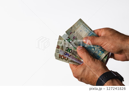Counting various banknotes in hands, close-up view Counting various banknotes in hands, close-up view 127241826