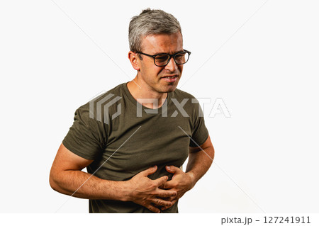 Man experiencing discomfort in abdominal area at home 127241911