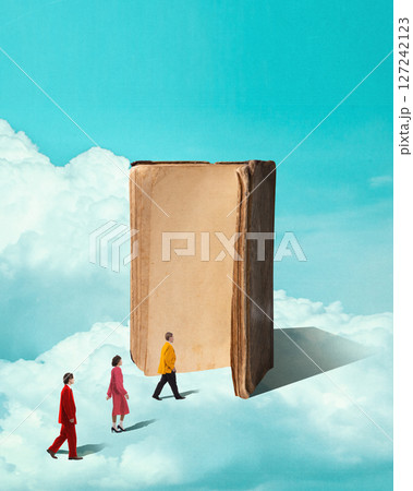 People walk along clouds toward huge standing book, floating in sky, representing collective rise through knowledge and reading. 127242123